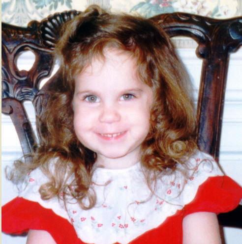 A baby holding a pom

Description automatically generated
