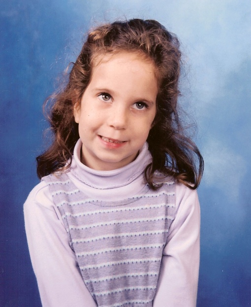 A young child sitting in a chair

Description automatically generated