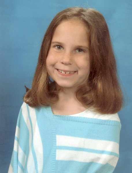 A child smiling at the camera

Description automatically generated