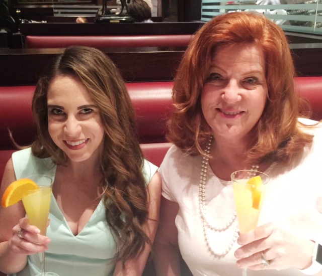 Two women holding drinks

Description automatically generated