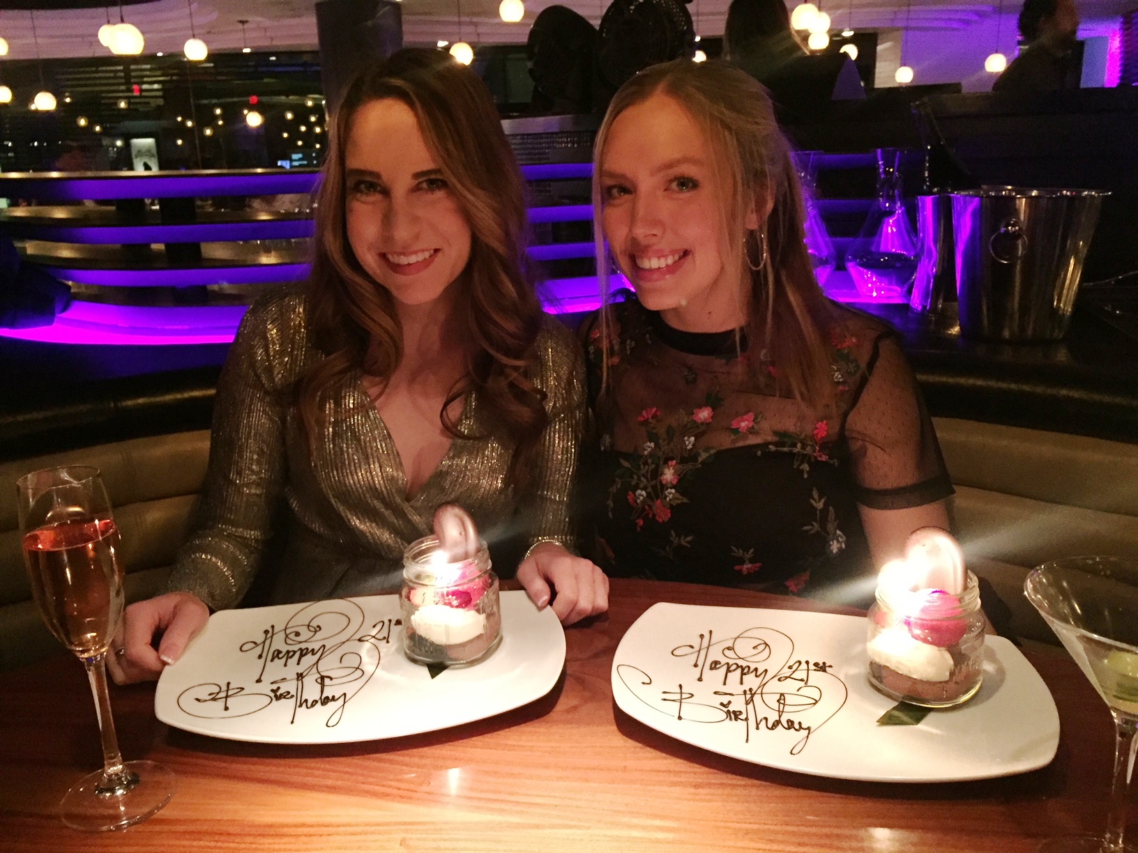 Two women sitting at a table with plates of food

Description automatically generated