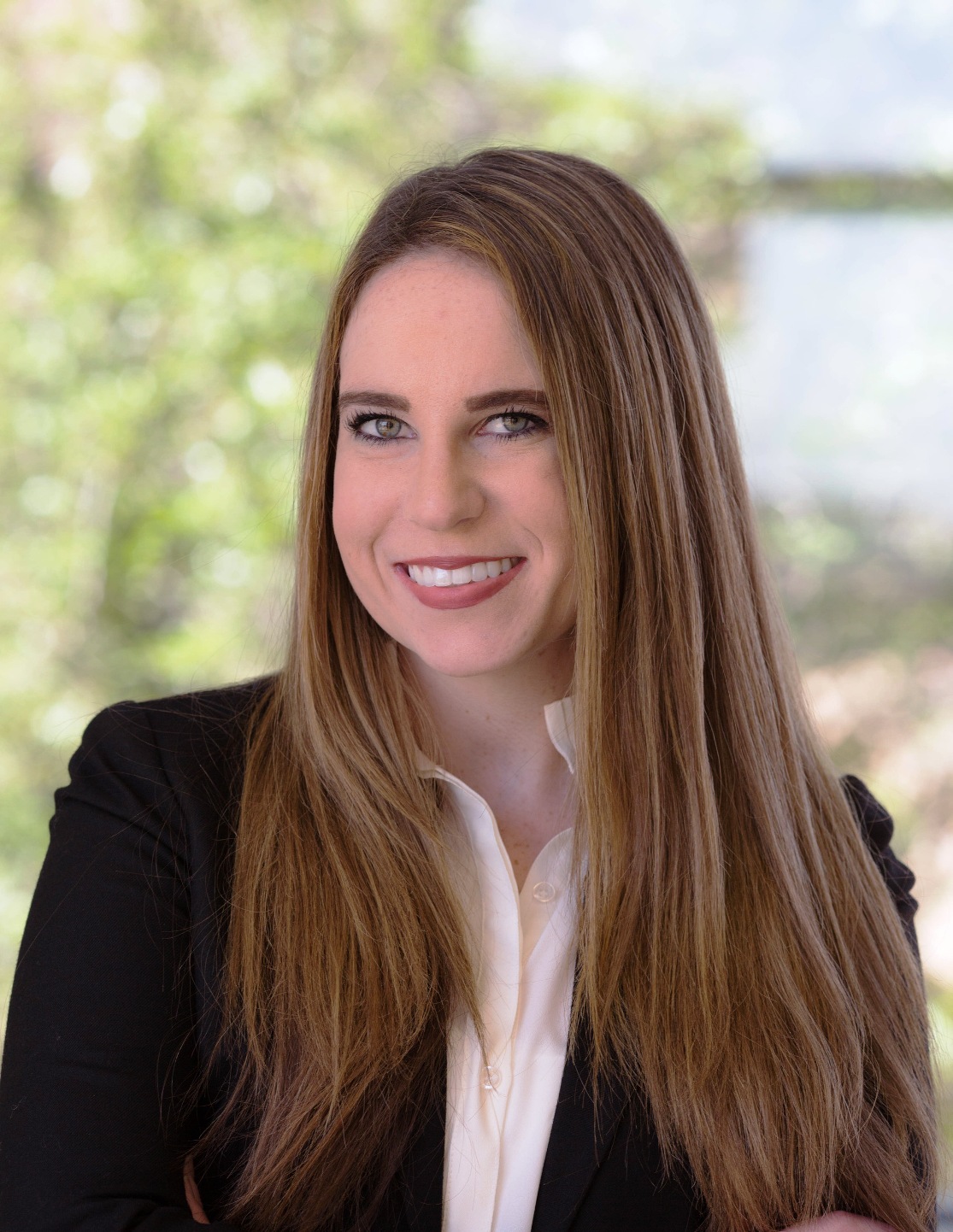 A person with long hair smiling

Description automatically generated