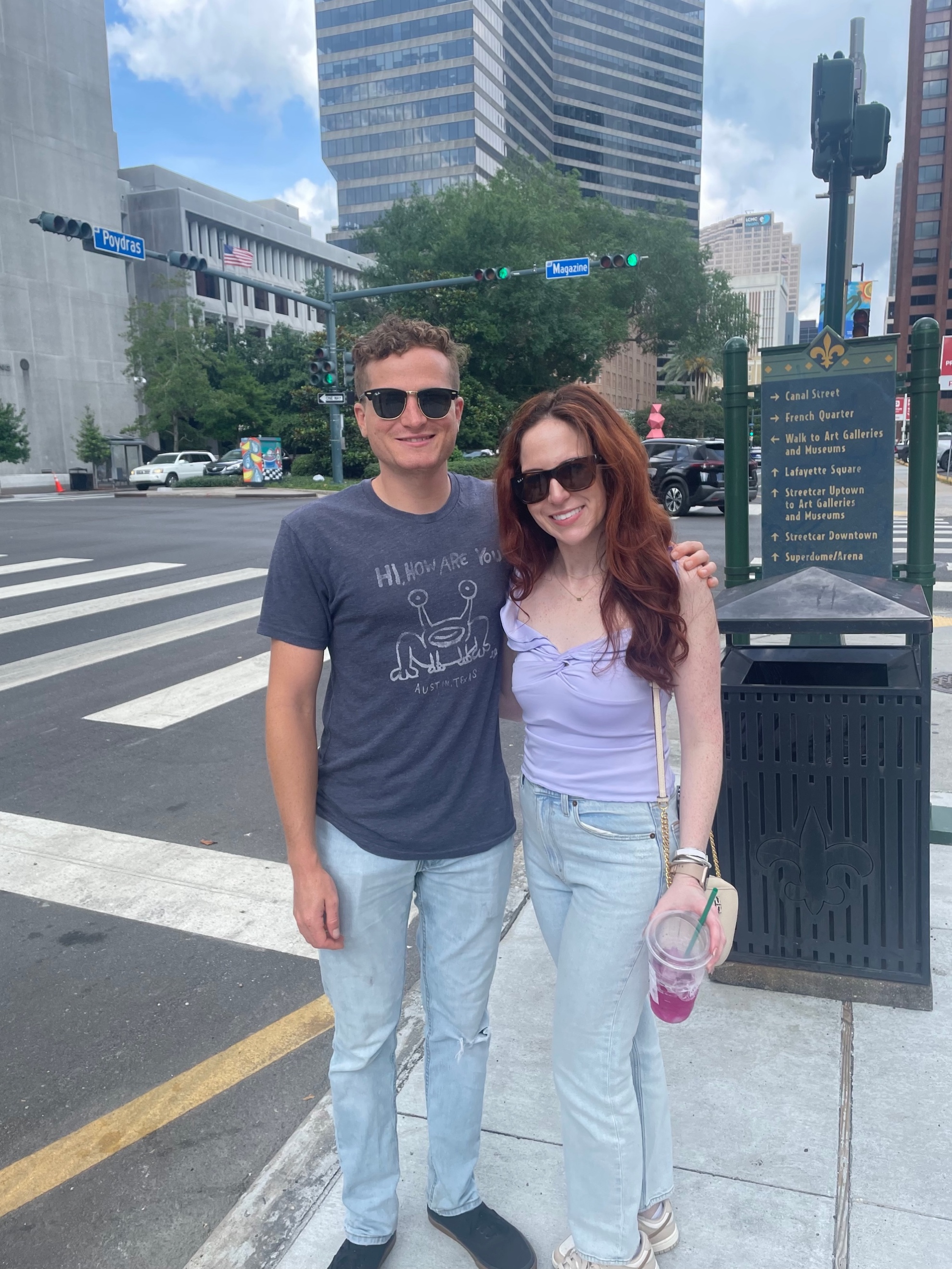 A person and person standing on a street
Description automatically generated