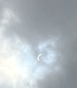 A crescent moon in the clouds
Description automatically generated