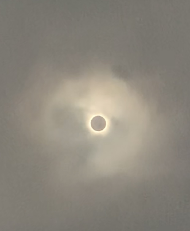 A sun eclipse in the clouds
Description automatically generated