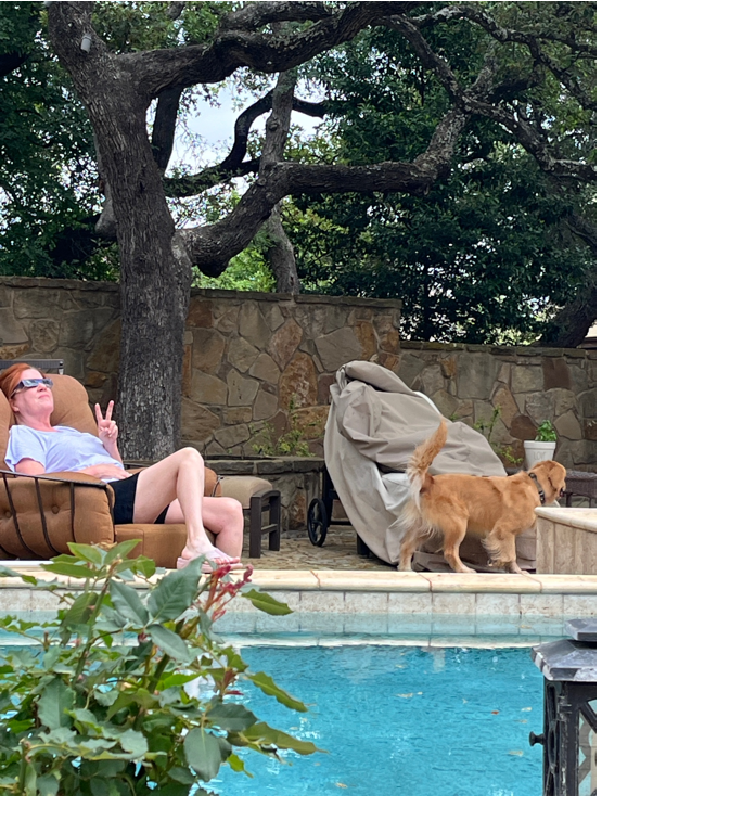 A person and dog by a pool
Description automatically generated